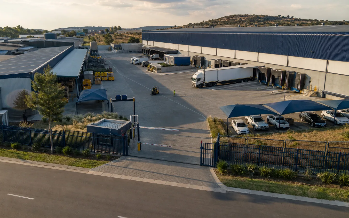 Aerial view of a gated industrial and logistics facility.