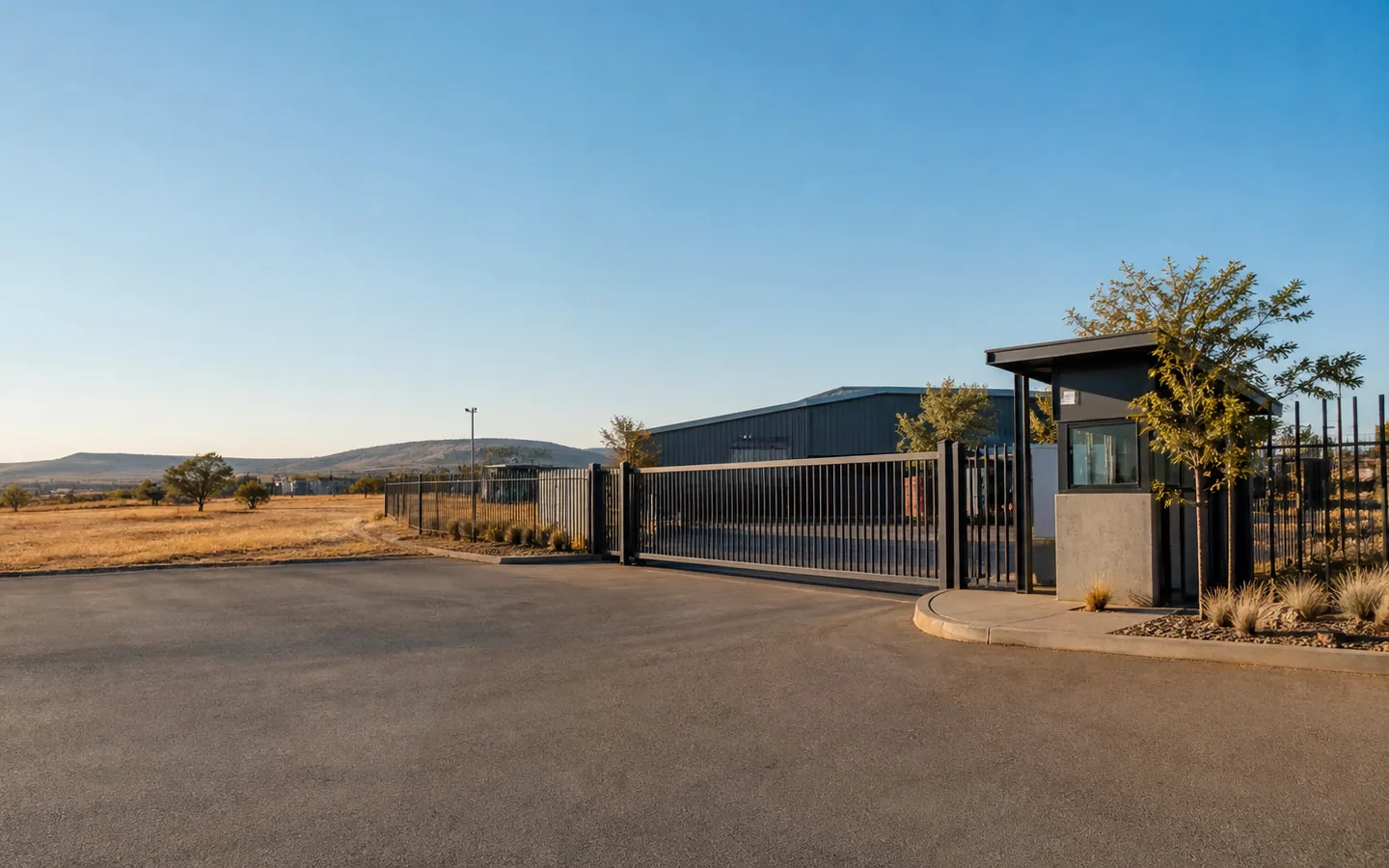 Controlled entrance to an industrial site in a remote landscape.